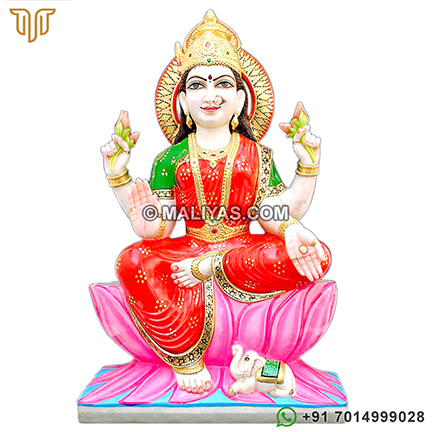 Laxmi Statue sitting on Lotus Flowers